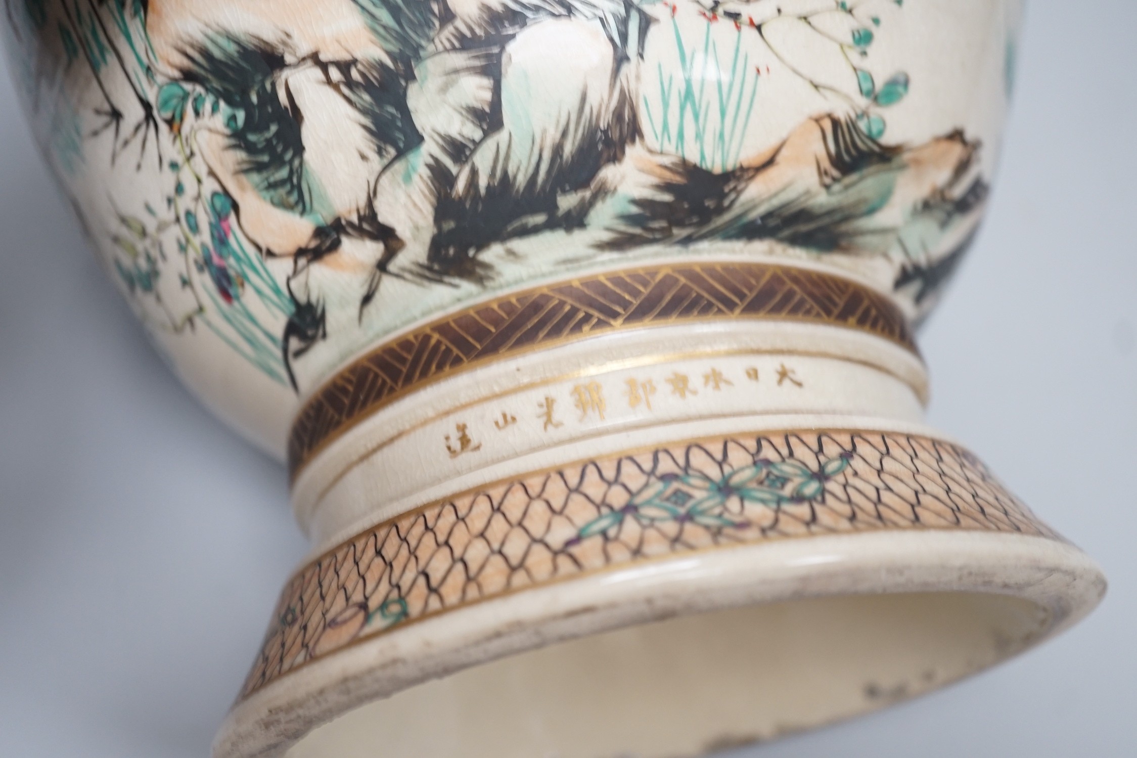 A pair of Japanese Satsuma pottery vases, Meiji period signed above foot, height 38cm